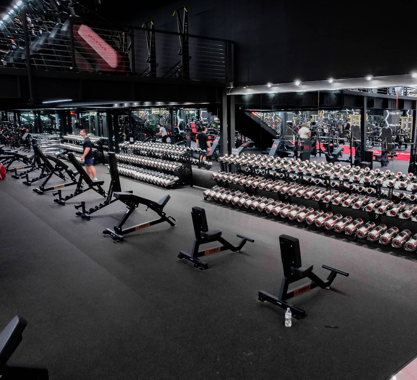 Strength training floor inside Absolute Recomp Fort Worth gym featuring dumbbell racks and premium equipment