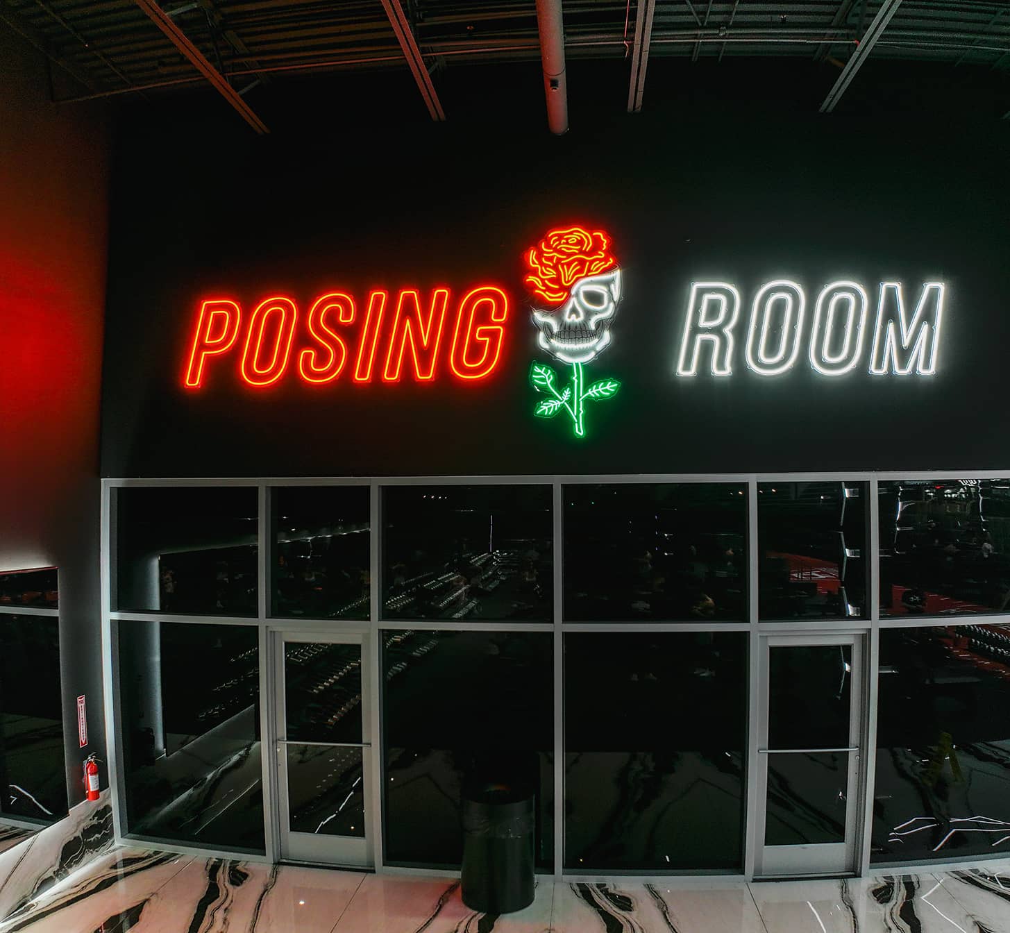 Posing room sign at Absolute Recomp Fort Worth with neon lettering and skull graphic
