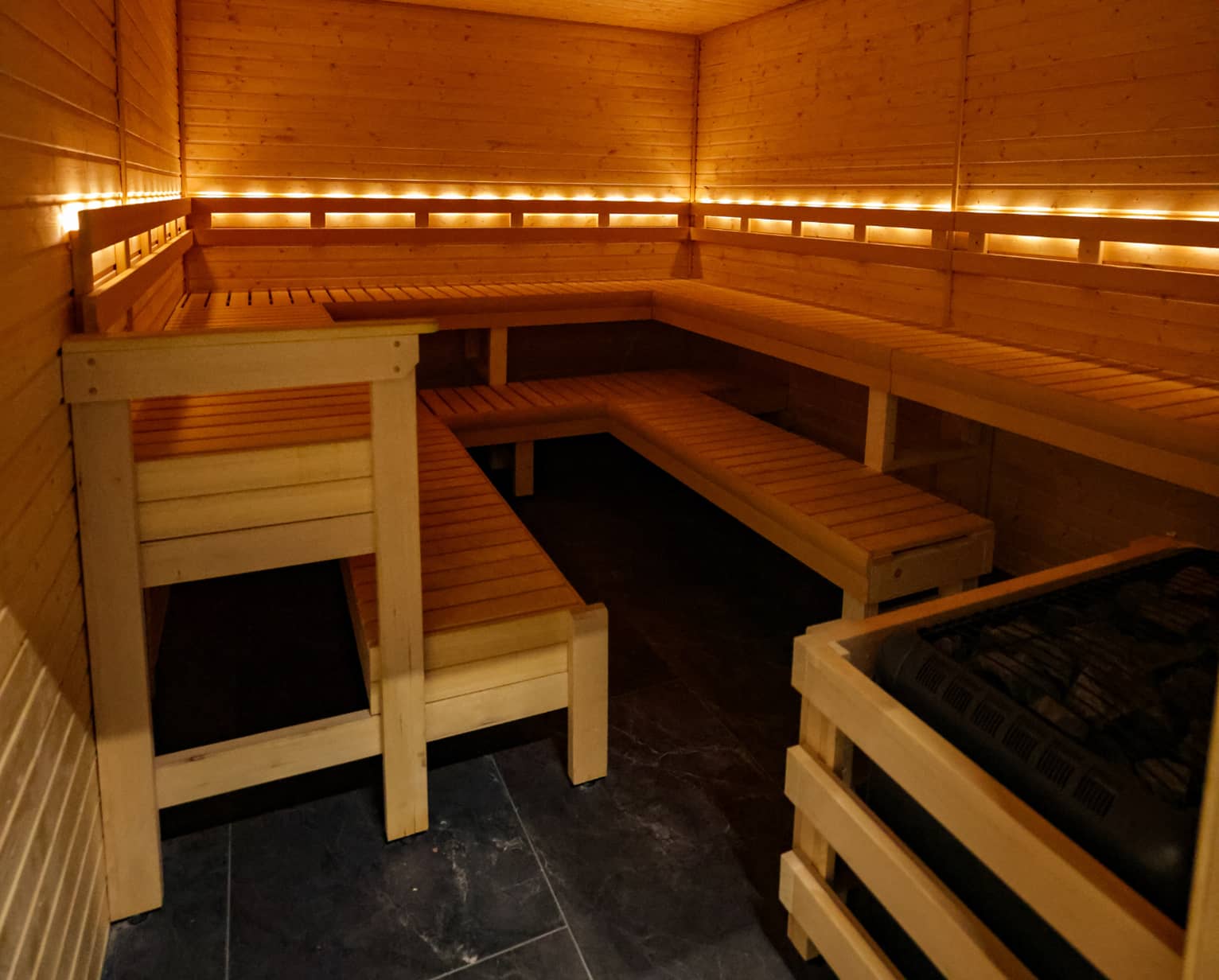 Sauna inside Absolute Recomp Fort Worth with wood interior and bench seating