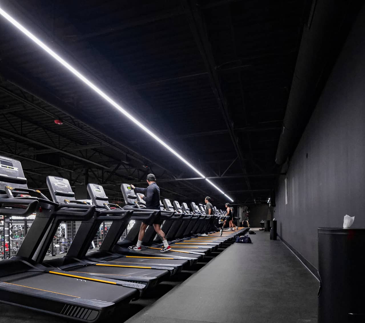 Cardio training area at Absolute Recomp Fort Worth with rows of treadmills