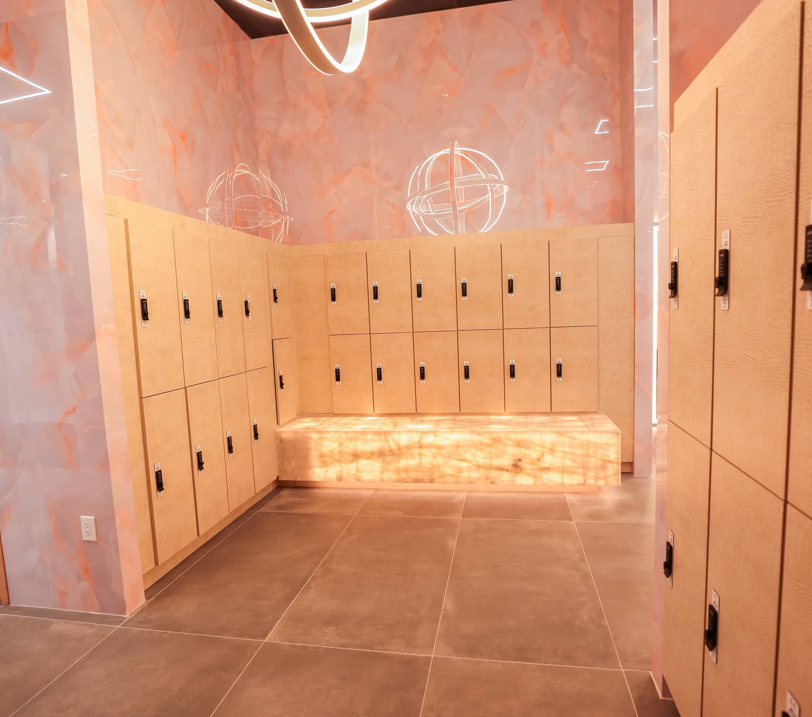 Locker area at Absolute Recomp Frisco with illuminated bench and personal storage lockers