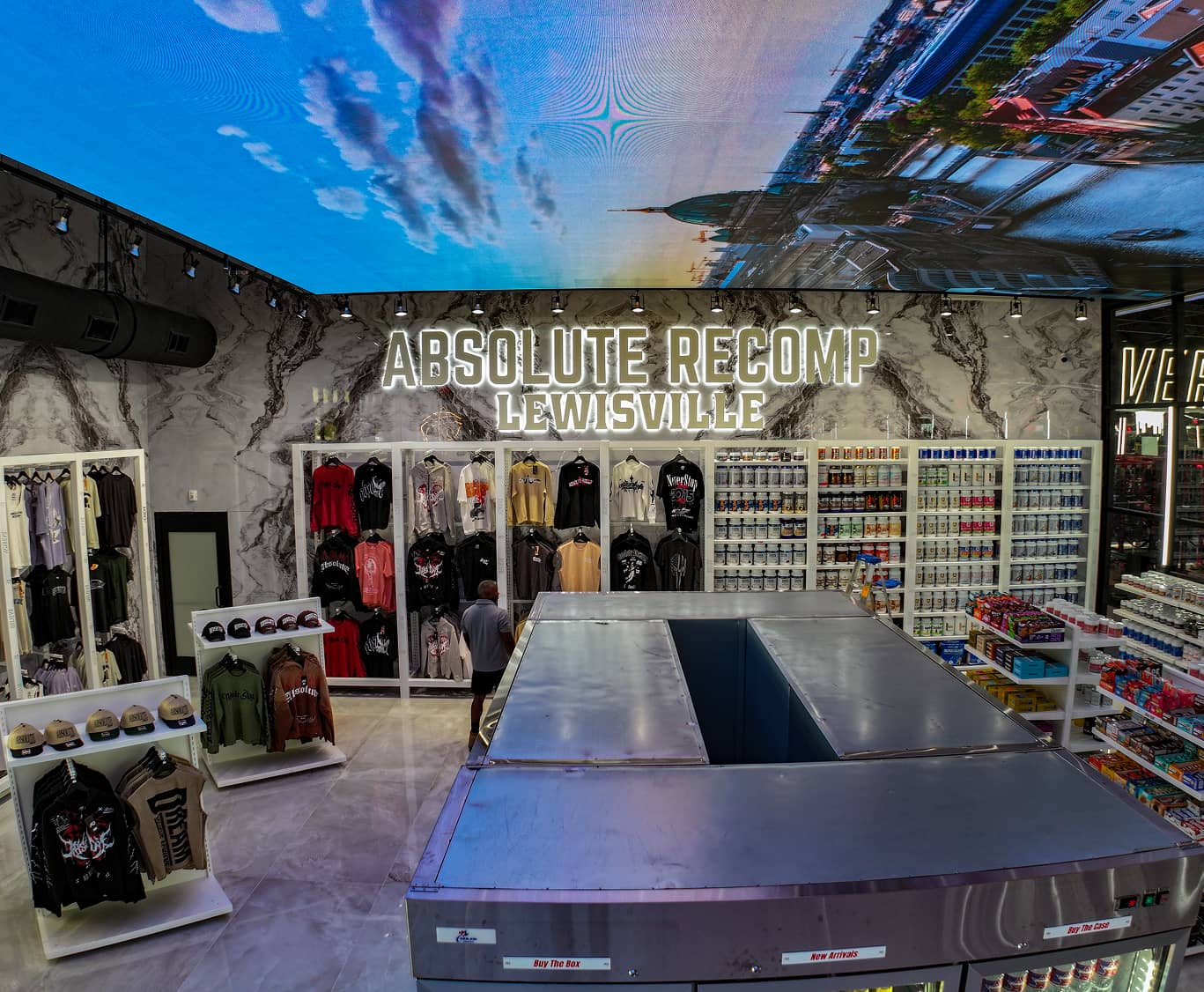 Merchandise and supplement shop at Absolute Recomp Lewisville with branded apparel and retail displays