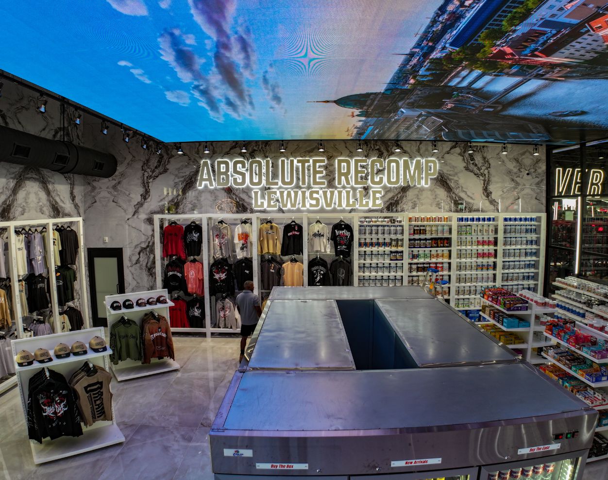 Retail area with branded apparel, hats, supplements, drinks, and snacks at Absolute Recomp Gyms Lewisville