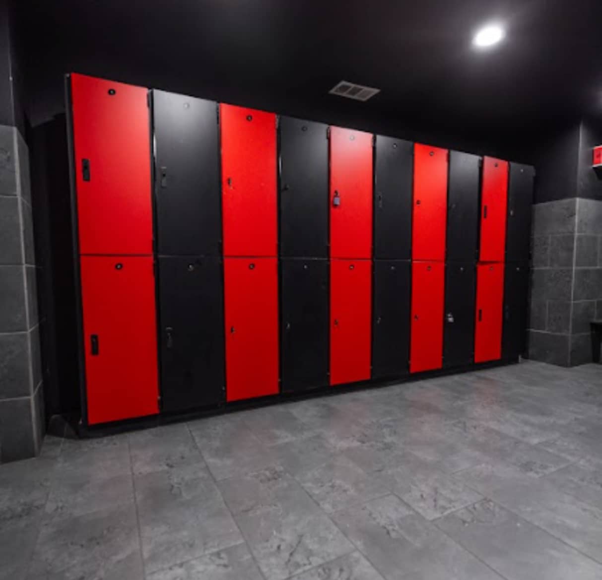 Locker room at Absolute Recomp North Richland Hills with red and black lockers
