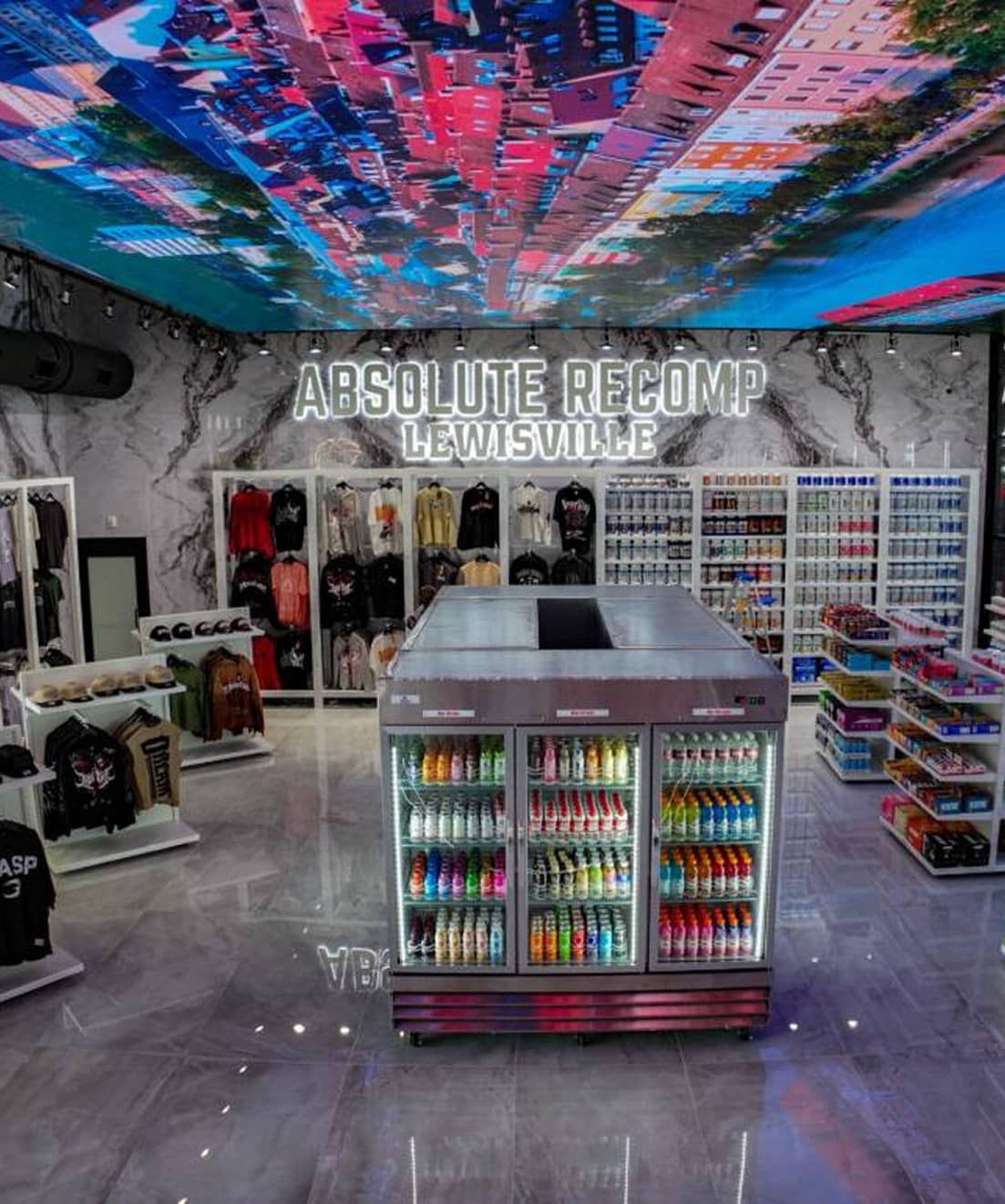Absolute Recomp Lewisville retail and supplement area with apparel and energy drinks display